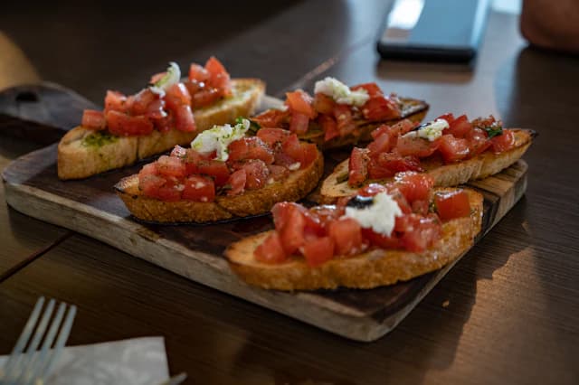 Toasted bruschetta topped with chopped tomatoes and herbs — illustrative stock photograph