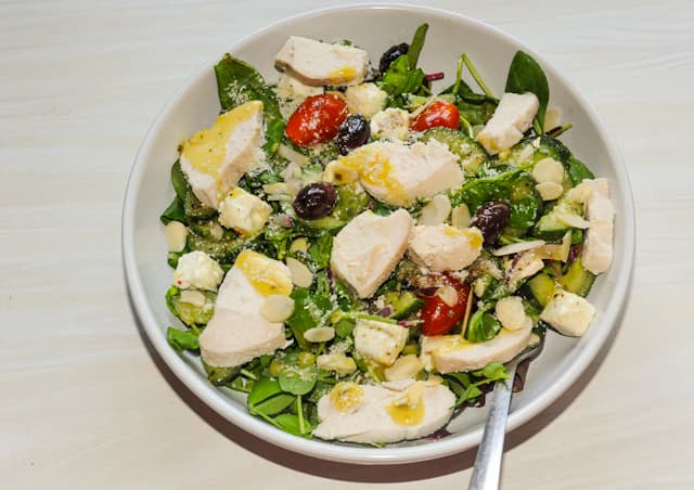 Caesar salad with lettuce, croutons and shaved parmesan — illustrative stock photograph