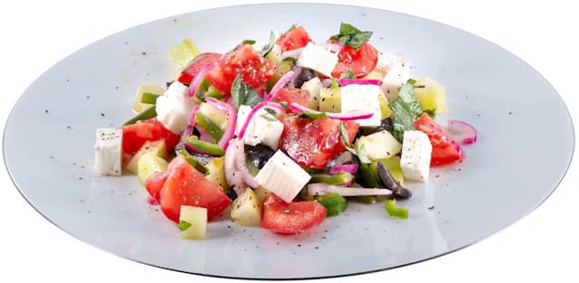 Chopped cucumber, tomatoes, olives and white feta cheese — illustrative stock photograph