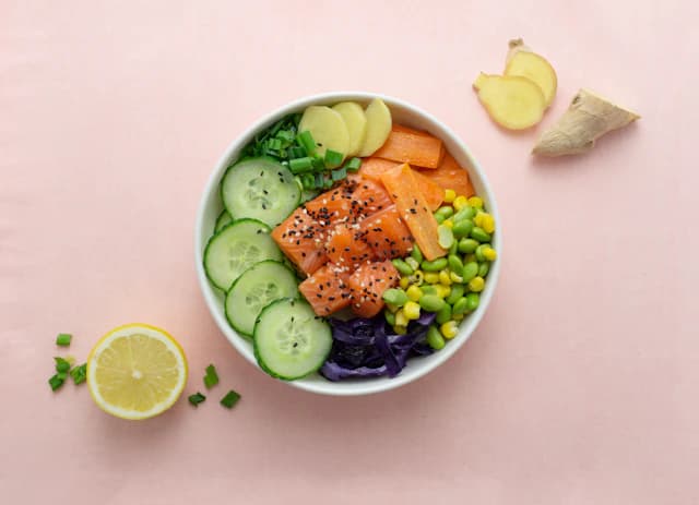 Glazed cooked salmon bowl with avocado and green vegetables — illustrative stock photograph