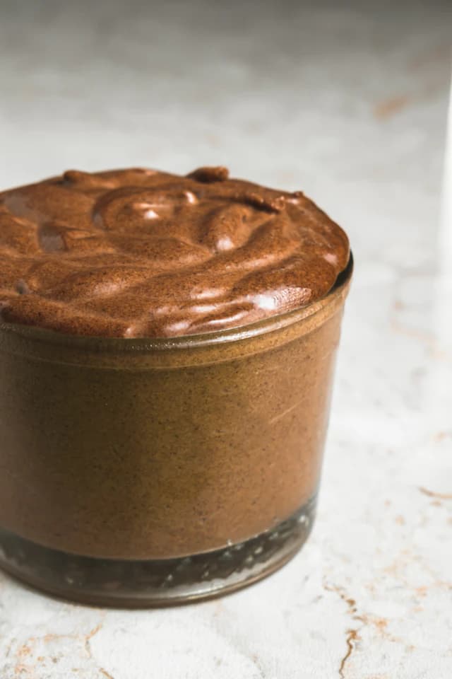 Chocolate mousse served in a small glass jar — illustrative stock photograph