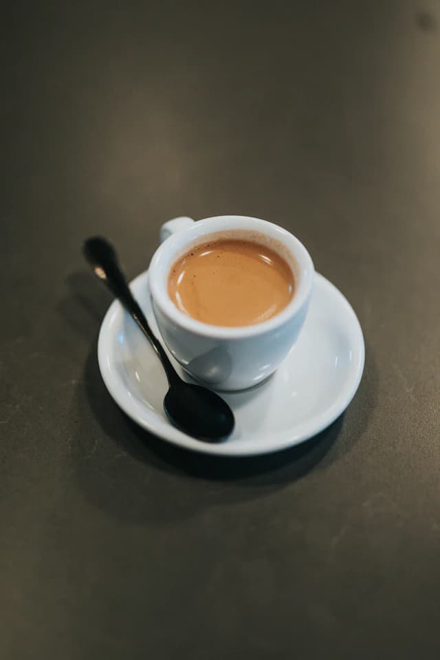 Small cup of rich espresso with crema — illustrative stock photograph